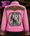 I Beg Your Parton pink denim jacket back view on mannequin, leopard print yoke and cuffs with rhinestone trim